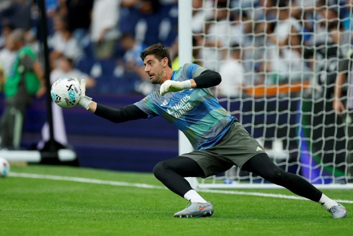 Real Madrid's Belgian goalkeeper #01 Thibaut Courtois warms up prior the Spanish league football match between Real Madrid CF and RCD Espanyol at the Santiago Bernabeu stadium in Madrid on September 20, 2025. Oscar DEL POZO / AFP