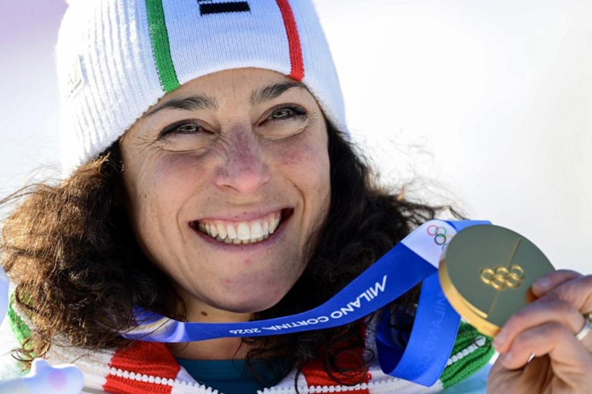 Gold medallist Italy's Federica Brignone poses on the podium of the women's giant slalom event during the Milano Cortina 2026 Winter Olympic Games at the Tofane Alpine Skiing Centre in Cortina d'Ampezzo on February 15, 2026. Stefano RELLANDINI / AFP