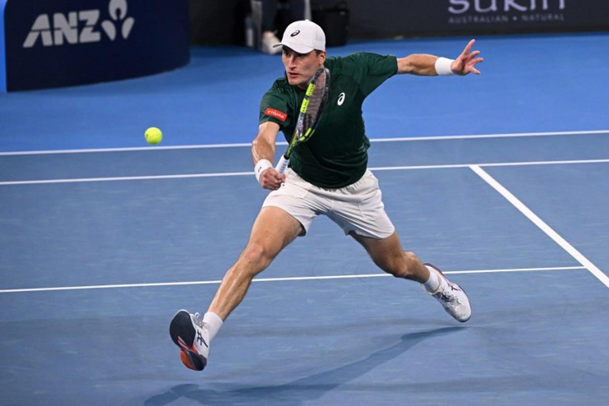 Belgium's Raphael Collignon hits a return to Bulgaria's Grigor Dimitrov during their men's singles match at the Brisbane International tennis tournament in Brisbane on January 8, 2026. William WEST / AFP