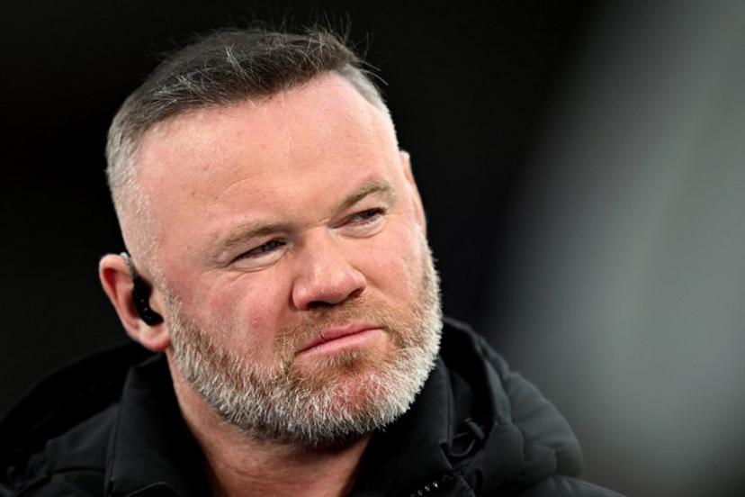 TV pundit and former footballer Wayne Rooney looks on before the UEFA Champions League quarter final, second-leg football match between Liverpool and Paris Saint-Germain at Anfield in Liverpool, north west England on April 14, 2026. Paul ELLIS / AFP