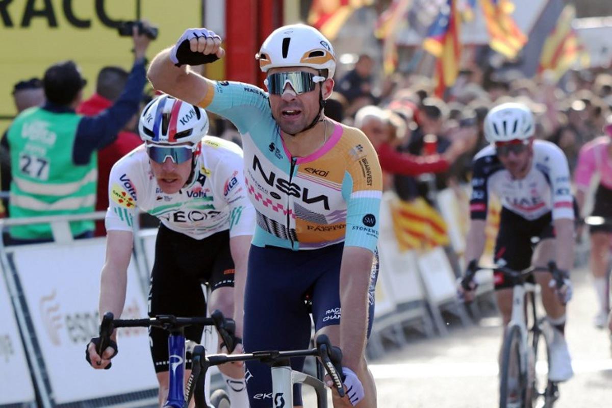 Team NSN Cycling Team's Welsh rider Ethan Vernon (C) celebrates ahead of Team Ineos' French rider Dorian Godon (L), after winning the 4th stage of the 2026 Volta a Catalunya cycling tour of Catalonia, a 151 km race between Mataro and Camprodon, on March 26, 2026. Josep LAGO / AFP