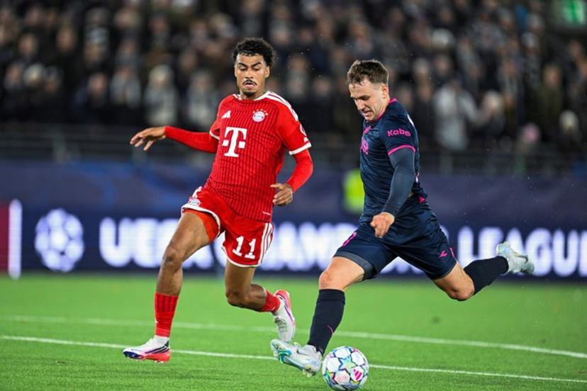 Viking's Danish forward #20 Peter Buch Christiansen (R) vies for the ball with with Bayern Munich's German defender #11 Nathaniel Brown during the UEFA Champions League football match between Viking FK and FC Bayern Munich in Stavanger, Norway on October 13, 2026. Carina Johansen / NTB / AFP
