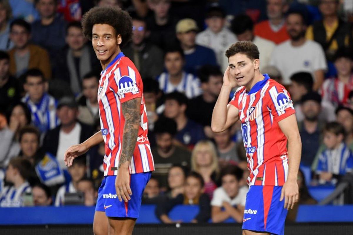 Atletico Madrid's Argentine forward #19 Julian Alvarez (R) celebrates scoring the opening goal next to Atletico Madrid's Belgian midfielder #20 Axel Witsel during the Spanish league football match between Real Sociedad and Club Atletico de Madrid at the Anoeta stadium in San Sebastian on October 6, 2024. Ander Gillenea / AFP