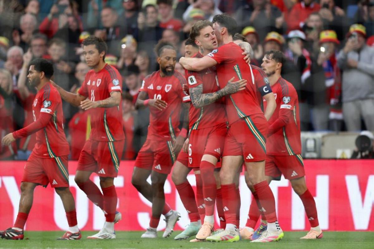 Wales' defender #06 Joe Rodon (C) celebrates with teammates after scoring the first goal during the 2026 World Cup Group J qualifier football match between Wales and Liechtenstein, at Cardiff City Stadium, in Cardiff, on June 6, 2025. Darren Staples / AFP