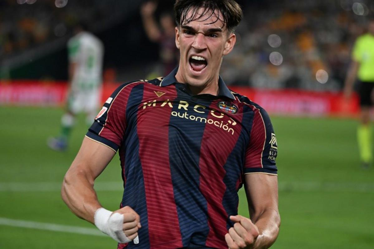 Levante's Spanish forward #19 Carlos Espi Escrihuela celebrates scoring his team's first goal during the Spanish league football match between Real Betis and Levante UD at Benito Villamarin Stadium in Seville on May 23, 2026. CRISTINA QUICLER / AFP