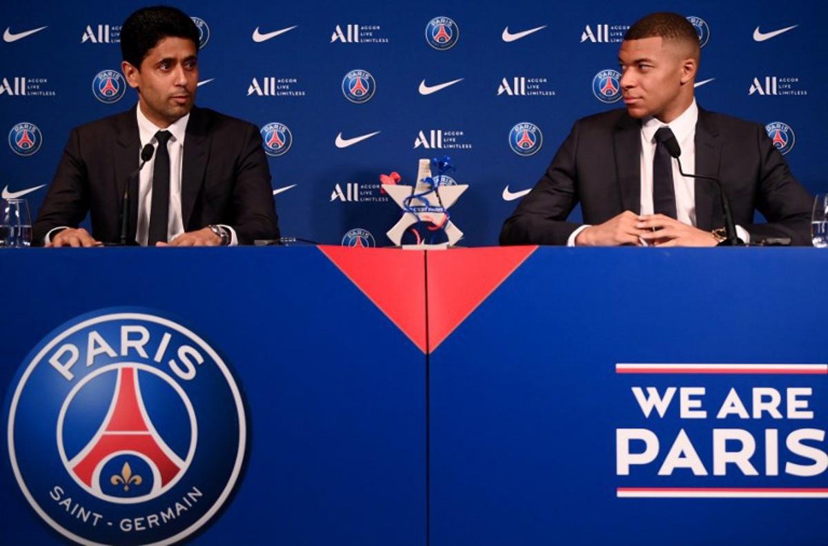 Paris Saint-Germain's CEO Nasser Al-Khelaifi (L) and French forward Kylian Mbappe (R) give a press conference at the Parc des Princes stadium in Paris on May 23, 2022, two days after the club won the Ligue 1 title for a record-equalling tenth time and its superstar striker Mbappe chose to sign a new contract at PSG rather than join Real Madrid. FRANCK FIFE / AFP