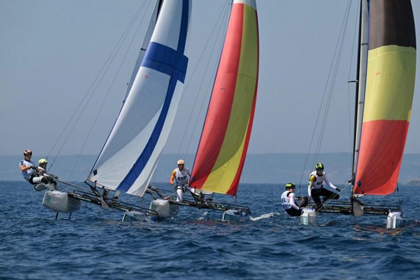 (LtoR) Finland's duo Sinem Kurtbay and Akseli Keskinen, Spain's duo Tara Pacheco van Rijnsoever and Andres Barrio Garcia and Belgium's duo Lucas Claeyssens and Eline Verstraelen compete in race 11 of the mixed Nacra 17 multihull event during the Paris 2024 Olympic Games sailing competition at the Roucas-Blanc Marina in Marseille on August 6, 2024. NICOLAS TUCAT / AFP
