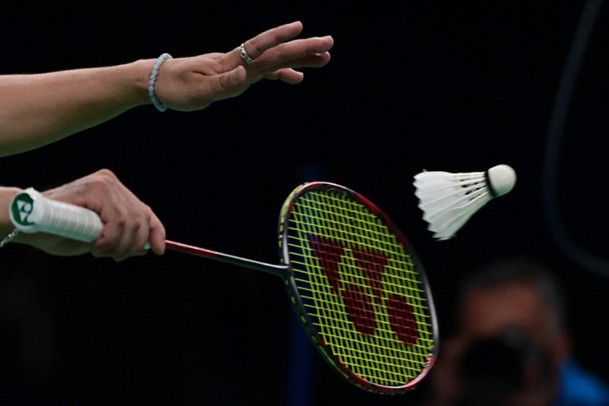 Canada's Xingyu Dong serves against Brazil's Davi Carvalho and Fabricio Rocha in the Badminton men's doubles final event of the Pan American Games Santiago 2023, at the Centro de Entrenamiento Olimpico in Santiago on October 25, 2023. Pablo VERA / AFP