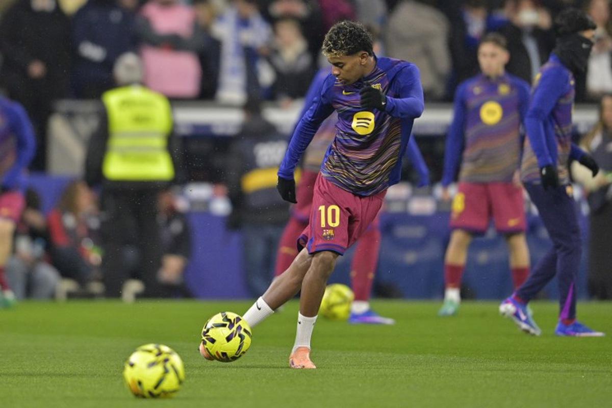 Barcelona's Spanish forward #10 Lamine Yamal warms up before the Spanish League football match between RCD Espanyol and FC Barcelona at RCDE Stadium in Cornella de Llobregat on January 3, 2026. MANAURE QUINTERO / AFP
