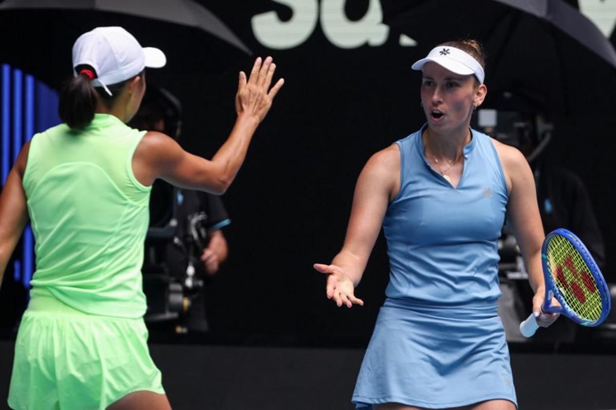 Belgium's Elise Mertens (R) gestures to partner China's Zhang Shuai during their women's doubles final match against Kazakhstan's Anna Danilina and Serbia's Aleksandra Krunic on day fourteen of the Australian Open tennis tournament in Melbourne on January 31, 2026. DAVID GRAY / AFP