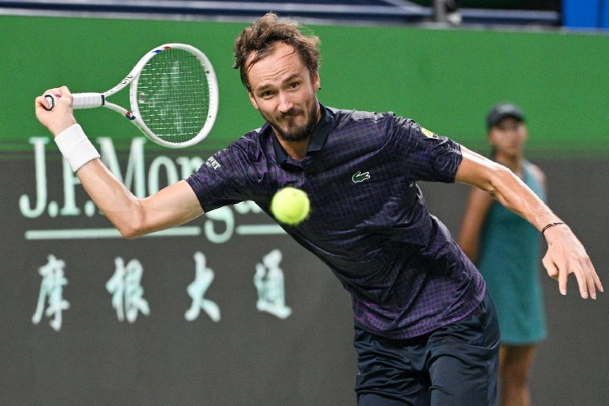 Russia's Daniil Medvedev hits a return to France's Arthur Rinderknech during their men's singles semi-final match at the Shanghai Masters tennis tournament in Shanghai on October 11, 2025. Hector RETAMAL / AFP