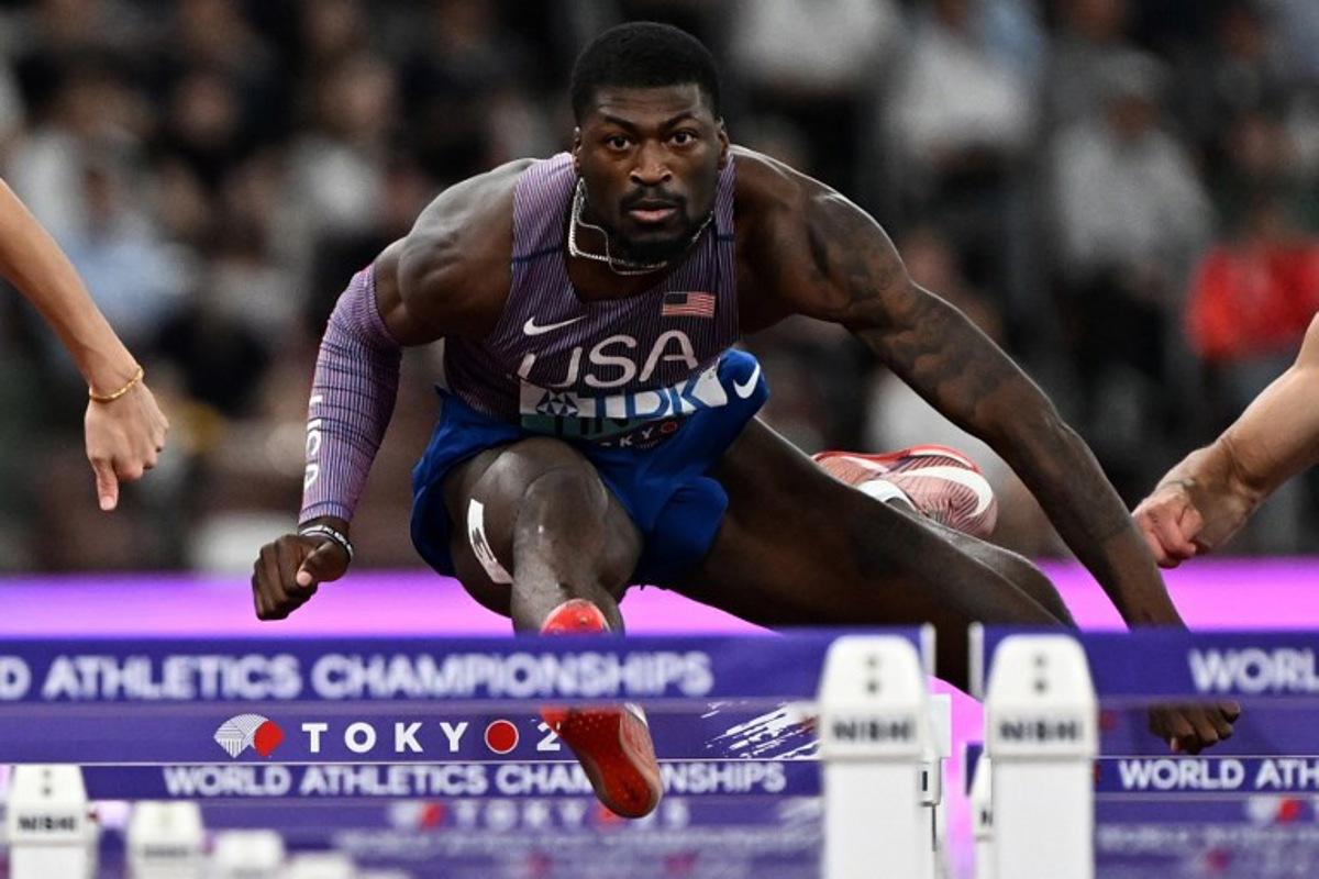 US' athlete Cordell Tinch competes in the men's 110m hurdles semi-final during the World Athletics Championships in Tokyo on September 16, 2025. Jewel SAMAD / AFP