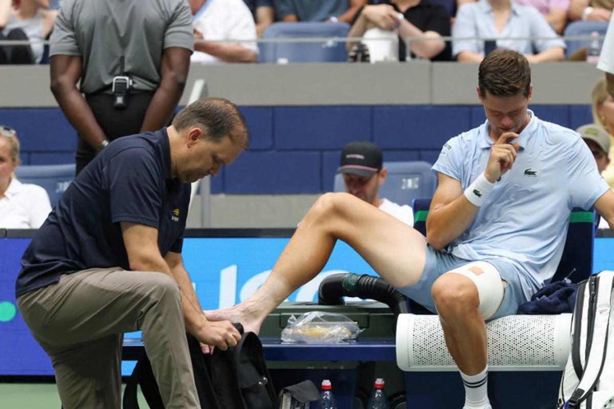 Belgium's Alexander Blockx receives medical attention as he plays Russia's Karen Khachanov in their men's singles quarter-final tennis match on day eleven of the US Open tennis tournament at the USTA Billie Jean King National Tennis Center in New York on September 9, 2026. TIMOTHY A. CLARY / AFP