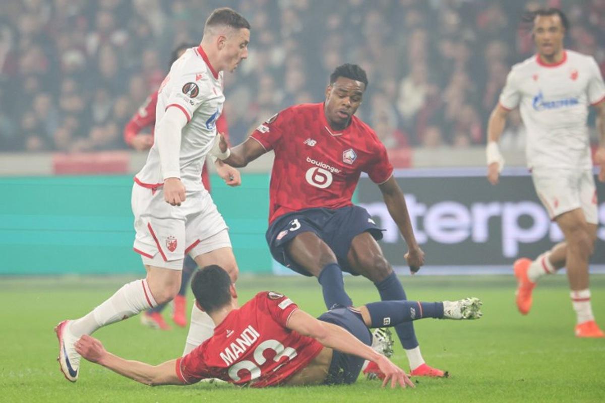 Crvena Zvezda Beograd's Brazilian forward #17 Bruno (L) fights for the ball with Lille's Algerian defender #23 Aissa Mandi 52nd L) and Lille's Belgian defender #03 Nathan Ngoy (C) during the UEFA Europa League - knockout round play-off first leg - football match between LOSC Lille and FK Crvena Zvezda Beograd (Red Star Belgrade) at the Pierre Mauroy Stadium in Villeneuve d'Ascq, northern France, on February 19, 2026. Francois LO PRESTI / AFP