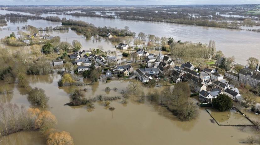 This aerial photograph taken on February 17, 2026, shows the village of Denee submerged by the overflowing Loire River in Denee, western France. The swelling of the Loire River caused a "major flood" on February 17, 2026 near Angers as three departments — Maine-et-Loire, Gironde and Lot-et-Garonne — remain under red alert, the highest warning level. Damien MEYER / AFP