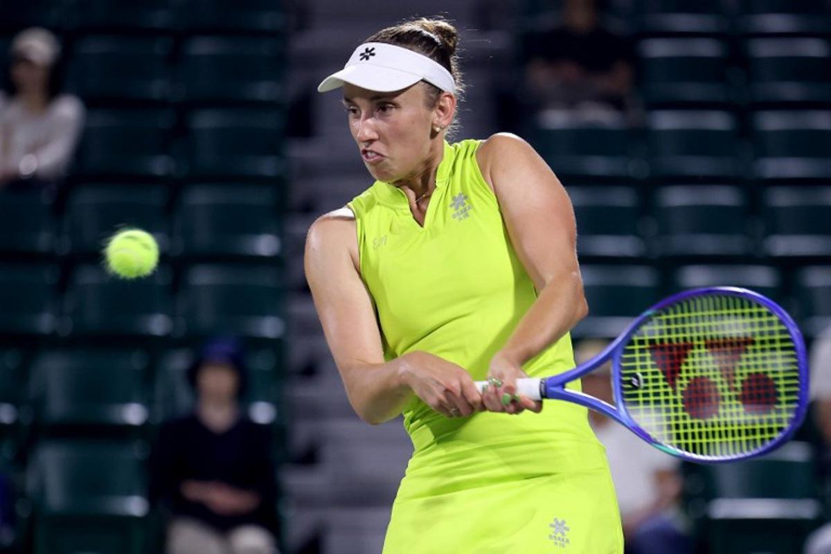 Belgium's Elise Mertens hits a return to Spain's Cristina Busca during their women's singles match at the Japan Open tennis tournament in Osaka on October 14, 2025. PAUL MILLER / AFP
