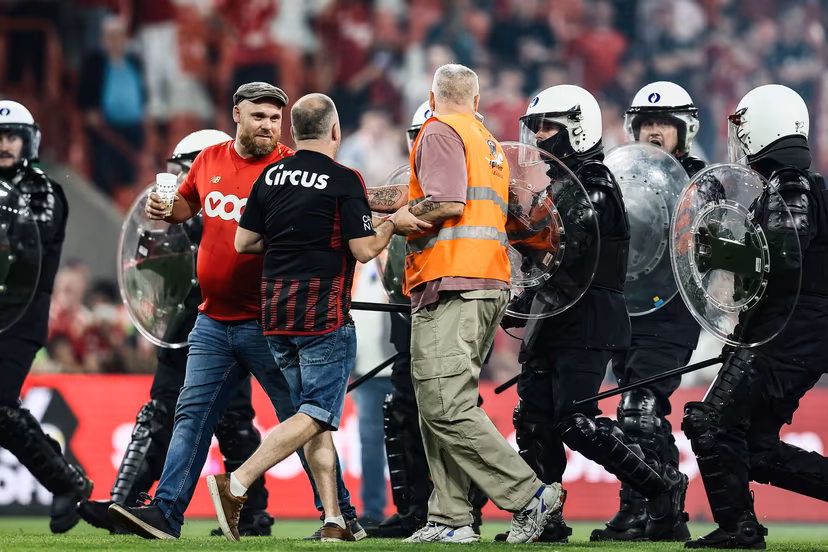 Standard's supporters and policemen on the pitch after a soccer match between Standard de Liege and Sporting Charleroi, Saturday 23 May 2026 in Liege, on the last day of the Europe Play-offs of the 2025-2026 'Jupiler Pro League' first division of the Belgian championship. BELGA PHOTO BRUNO FAHY