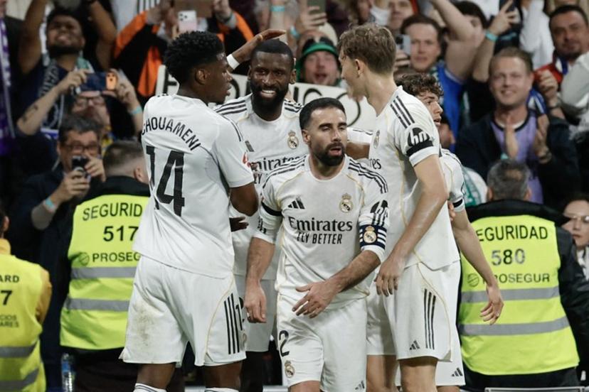 Real Madrid's German defender #22 Antonio Ruediger (2L) celebrates scoring his team's first goal during the Spanish league football match between Real Madrid CF and Elche CF at the Santiago Bernabeu Stadium in Madrid on March 14, 2026. Oscar DEL POZO / AFP
