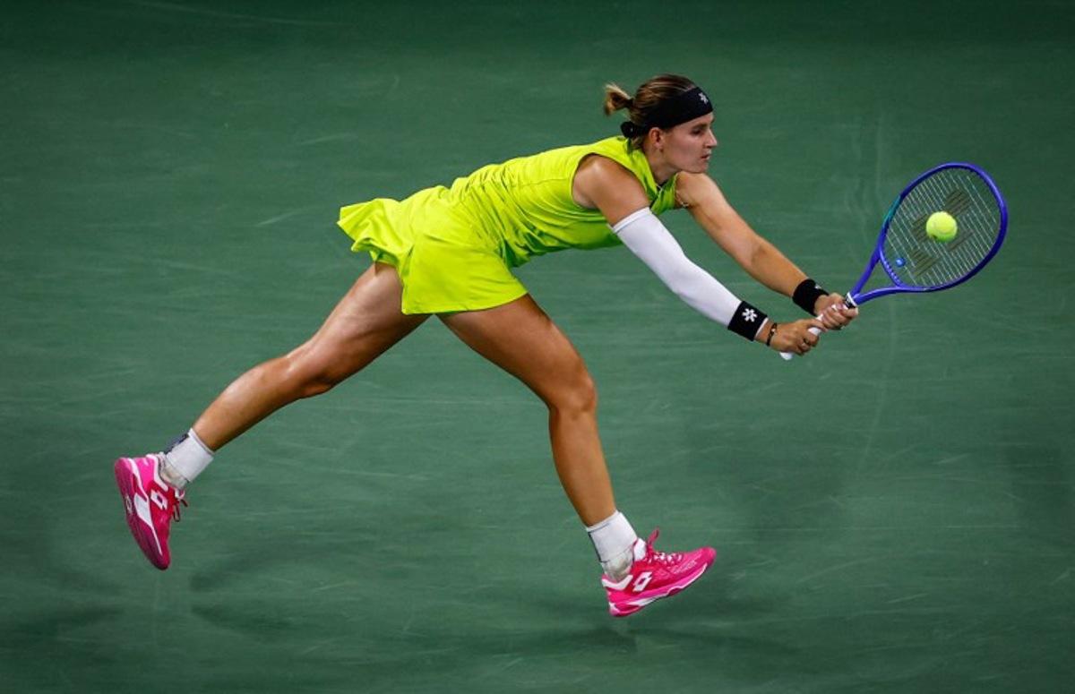 Belgium's Greet Minnen returns the ball to Japan's Naomi Osaka during their women's singles first round tennis match on day three of the US Open tennis tournament at the USTA Billie Jean King National Tennis Center in New York City, on August 26, 2025. Kena Betancur / AFP