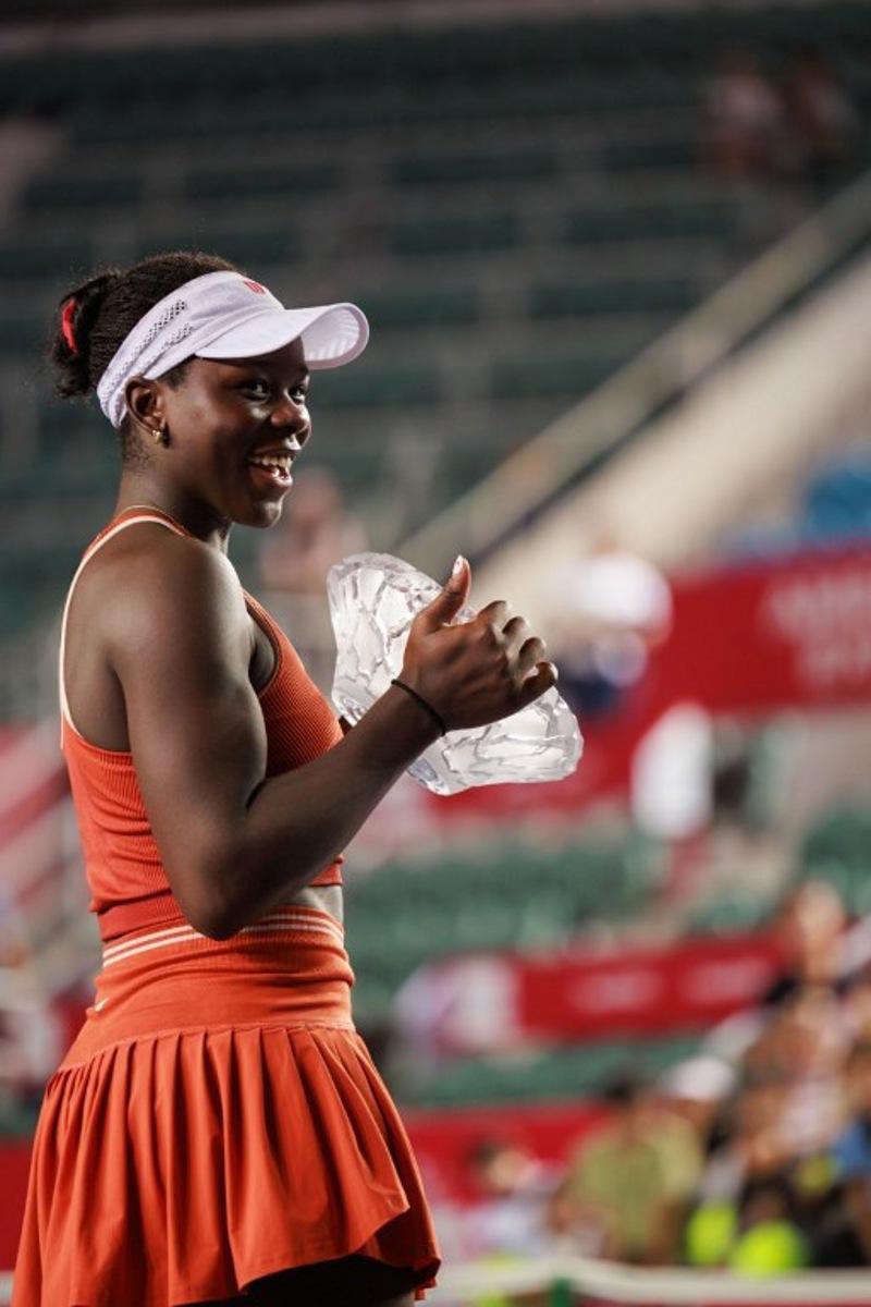 Victoria Mboko of Canada holds the trophy after winning against Cristina Bucsa of Spain in the women's singles final of the Hong Kong Tennis Open in Hong Kong on November 2, 2025. May JAMES / AFP