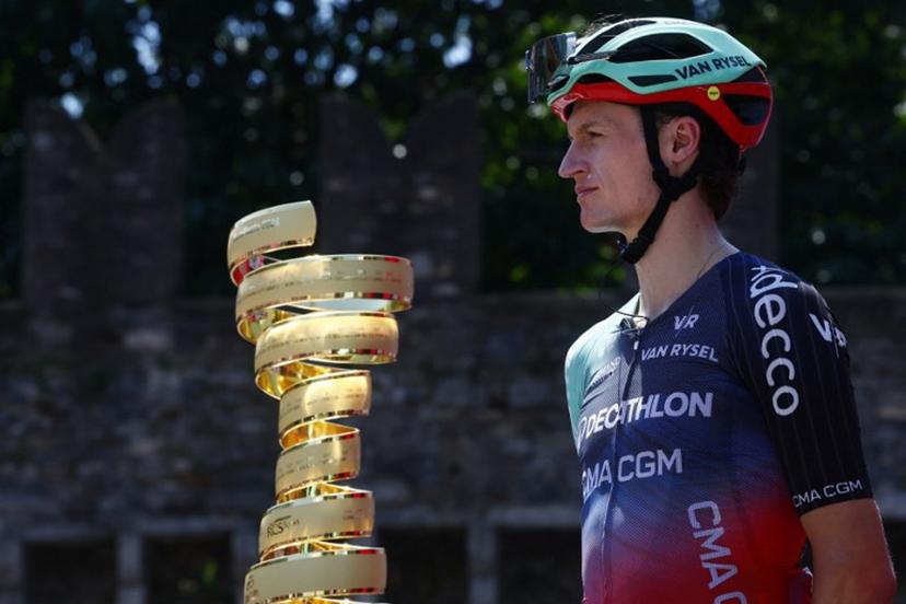 Decathlon CMA CGM Team Austrian rider Felix Gall looks on near the Giro d'Italia trophy ("trofeo senza fine") during the presentation prior the 16th stage of the Giro d'Italia 2026 - Tour of Italy cycling race between Bellinzona and Cari, Switzerland, on May 26, 2026. Luca Bettini / AFP