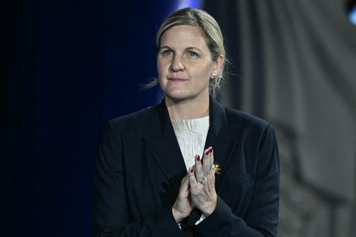 The President of the International Olympic Committee Kirsty Coventry reacts on the podium of the women's 100m backstroke swimming event during the 2025 World Aquatics Championships in Singapore on July 29, 2025. Oli SCARFF / AFP