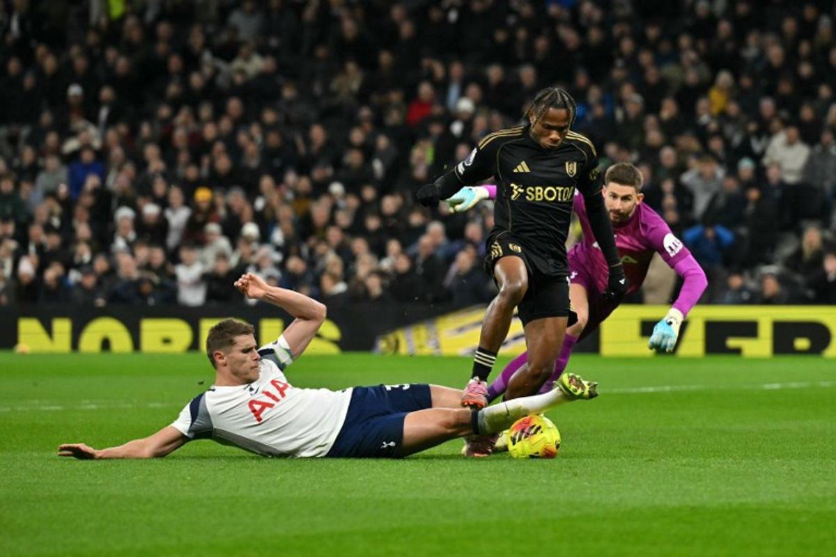 Tottenham Hotspur's Dutch defender #37 Micky van de Ven (L) tackles Fulham's Nigerian midfielder #19 Samuel Chukwueze during the English Premier League football match between Tottenham Hotspur and Fulham at the Tottenham Hotspur Stadium in London, on November 29, 2025. Glyn KIRK / AFP