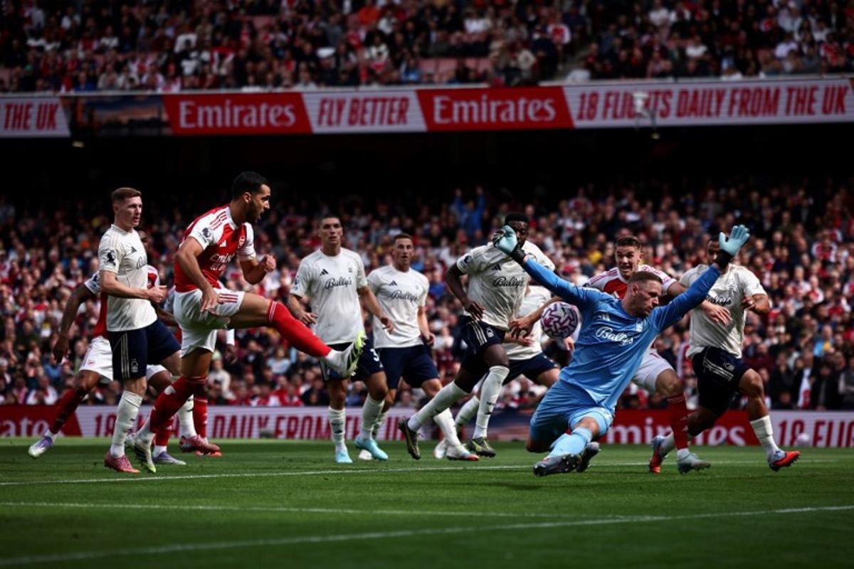 Nottingham Forest's Belgian goalkeeper #26 Matz Sels saves a shot from Arsenal's Spanish midfielder #23 Mikel Merino during the English Premier League football match between Arsenal and Nottingham Forest at the Emirates Stadium in London on September 13, 2025. HENRY NICHOLLS / AFP