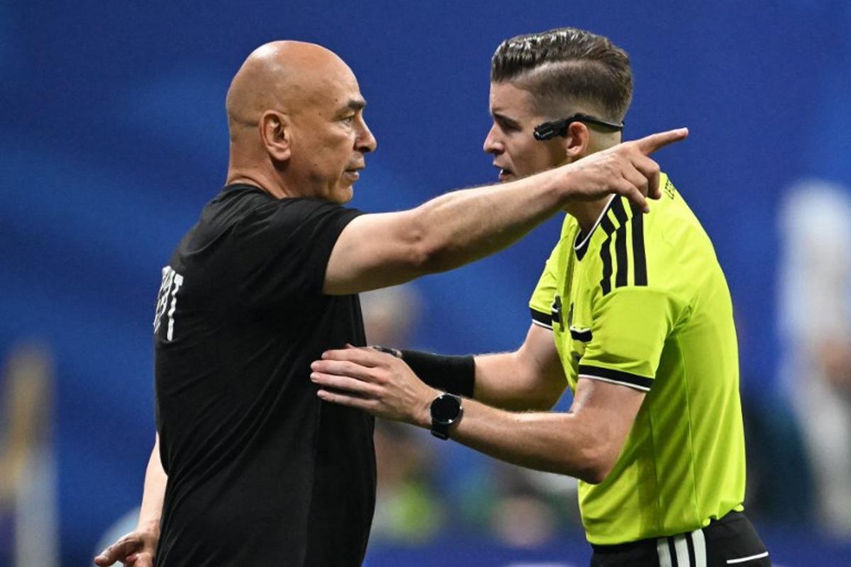 Egypt's head coach Hossam Hassan speaks with French referee Francois Letexier during the 2026 World Cup round of 16 football match between Argentina and Egypt at Atlanta Stadium in Atlanta on July 7, 2026. ROBERTO SCHMIDT / AFP