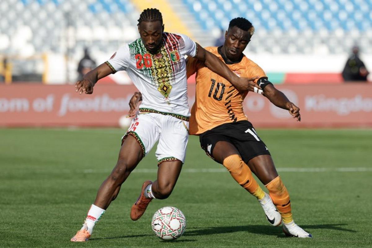 Mali's defender #26 Woyo Coulibaly (L) fights for the ball with Zambia's forward #10 Fashion Sakala (R) during the Africa Cup of Nations (AFCON) Group A football match between Mali and Zambia at Mohammed V Stadium in Casablanca, Morocco on December 22, 2025. Abdel Majid BZIOUAT / AFP