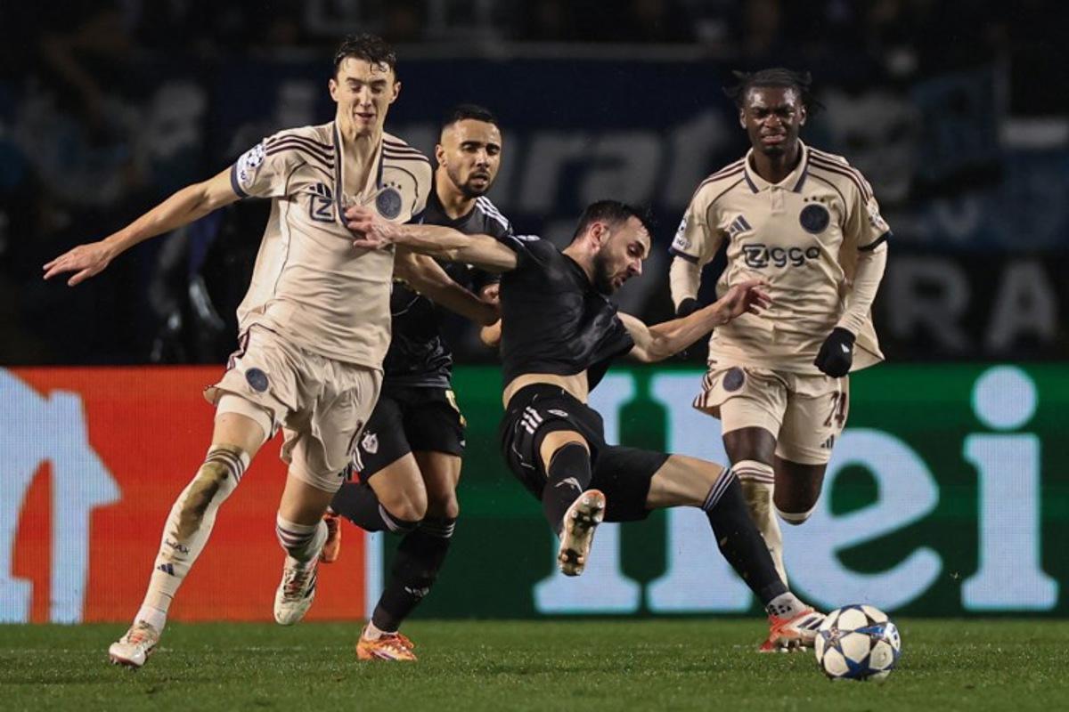 Ajax's Dutch defender #15 Youri Baas and Qarabag's Montenegrin midfielder #08 Marko Jankovic vie for the ball during the UEFA Champions League league phase football match between Qarabag and Ajax at the Tofiq Bahramov Republican Stadium in Baku on December 10, 2025. Giorgi ARJEVANIDZE / AFP
