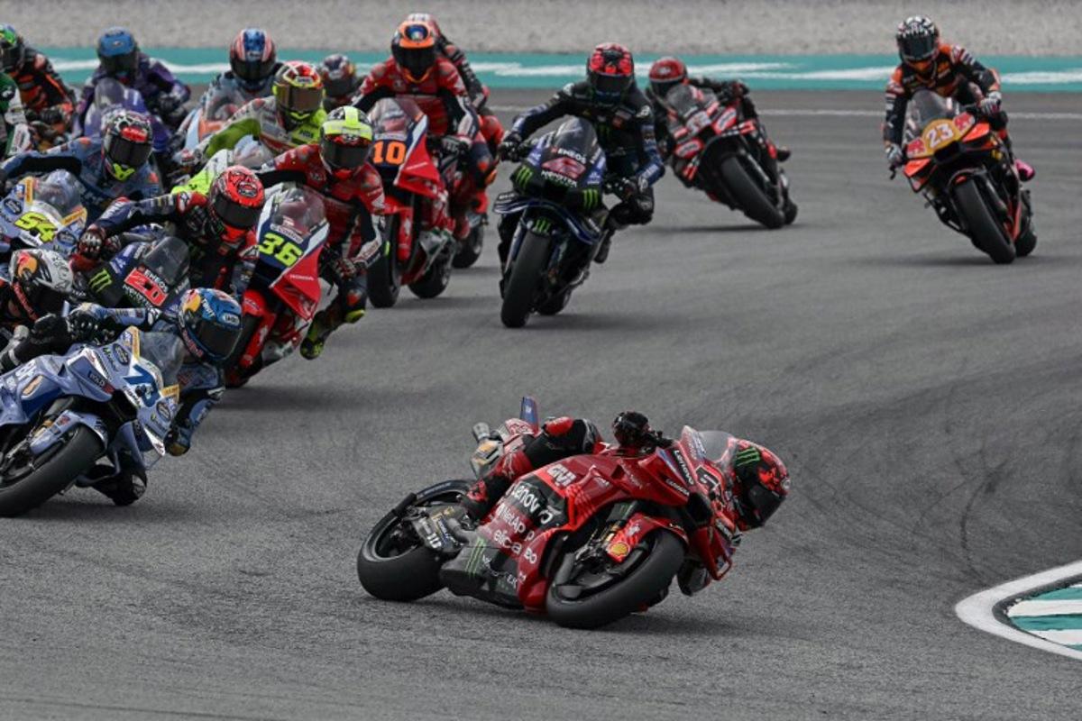Ducati Lenovo Team's Italian MotoGP rider Francesco Bagnaia (C) leads in the Sprint race of the MotoGP Malaysian Grand Prix at the Sepang International Circuit in Sepang on October 25, 2025.  Lillian SUWANRUMPHA / AFP