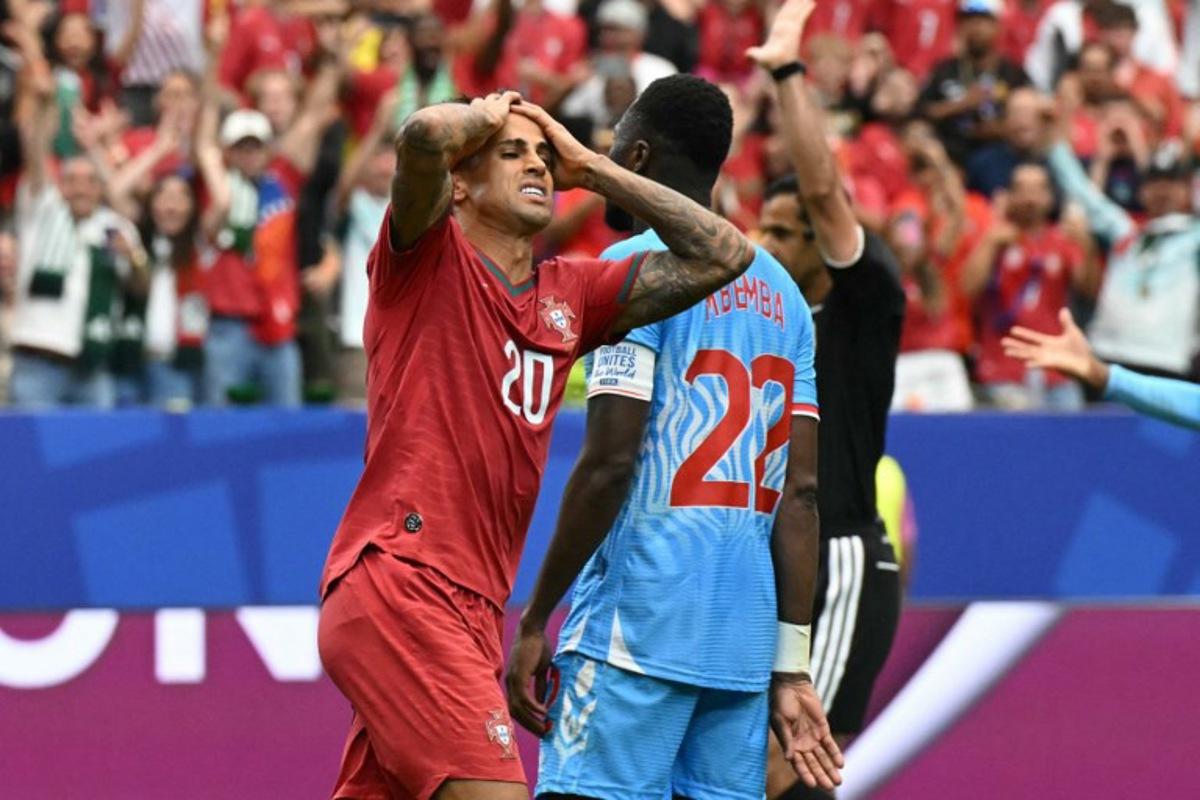 Portugal's defender #20 Joao Cancelo (L) reacts after missing a goal opportunity during the 2026 World Cup Group K football match between Portugal and the Democratic Republic of Congo at the Houston Stadium in Houston on June 17, 2026. RONALDO SCHEMIDT / AFP