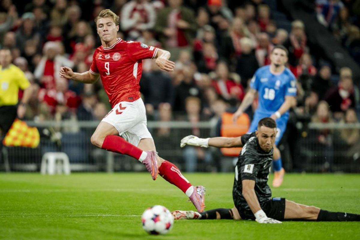 Denmark's forward #09 Rasmus Hojlund scores his team's first goal during the 2026 World Cup qualifiers Europe zone group G football match between Denmark and Greece on October 12, 2025 in Copenhagen. Mads Claus Rasmussen / Ritzau Scanpix / AFP