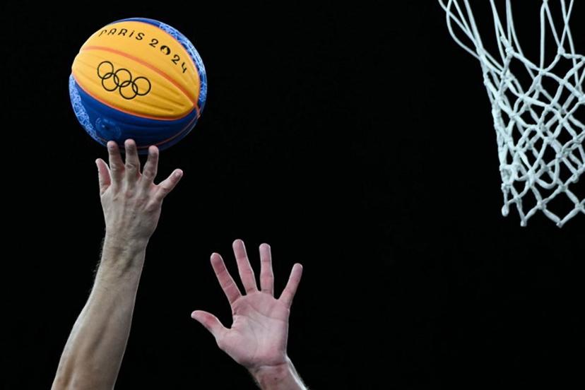 Players try to grab the ball next to the basket in the men's 3x3 basketball play-in games between Serbia and France during the Paris 2024 Olympic Games at La Concorde in Paris on August 4, 2024. Luis ROBAYO / AFP