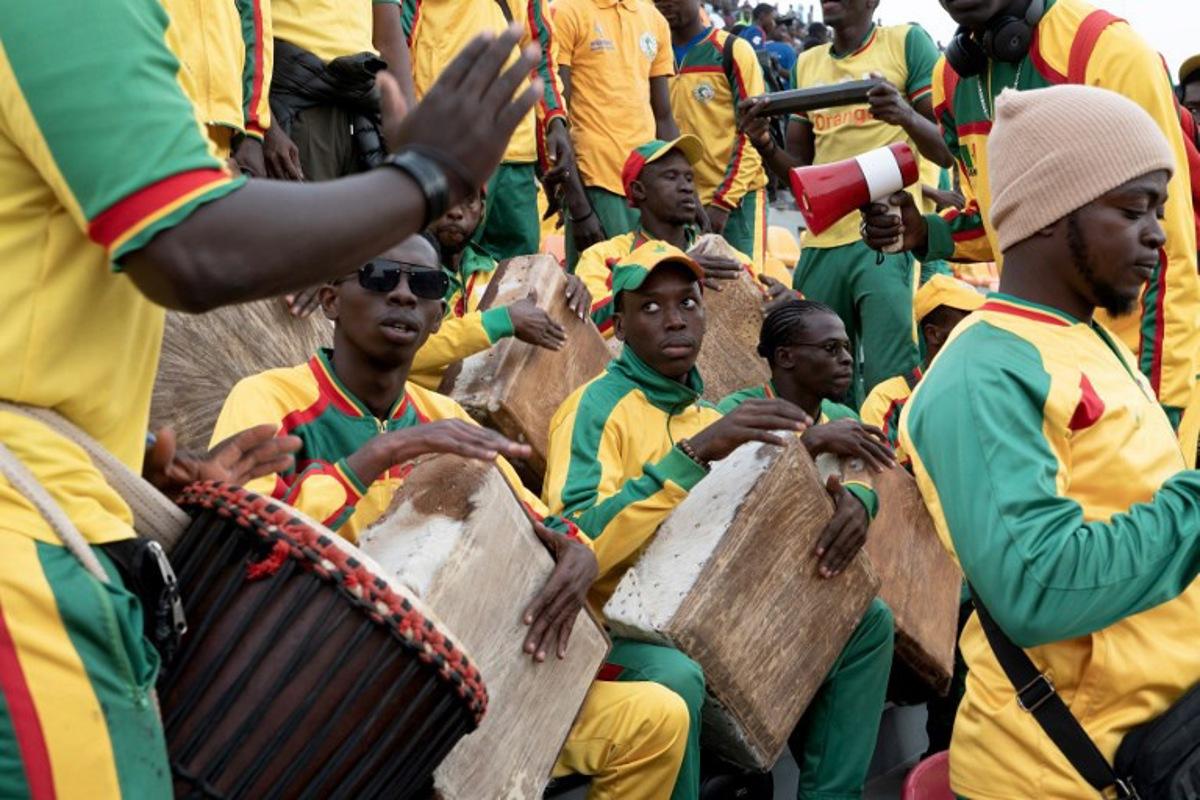 Lions of Senegal's supporters cheer during the Senegal's national football team last training session prior to the start of the 2025 Africa Cup of Nations hosted by Morocco, at the Leopaul Sedar Senghor stadium, in Dakar on December 18, 2025. SEYLLOU / AFP