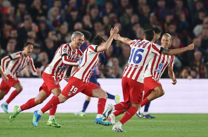 Atletico Madrid's Argentine forward #19 Julian Alvarez (R) celebrates scoring his team's first goal with teammates during the UEFA Champions League quarter final first leg football match between FC Barcelona and Club Atletico de Madrid at Camp Nou Stadium in Barcelona on April 8, 2026. Josep LAGO / AFP