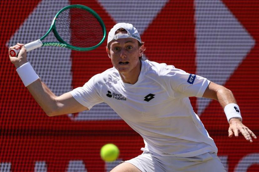 Peru's Ignacio Buse hits a return against Brandon Nakashima of the US during their men's singles round of 16 tennis match on day three of the ATP HSBC Championships at Queen's Club in west London on June 17, 2026. Adrian Dennis / AFP