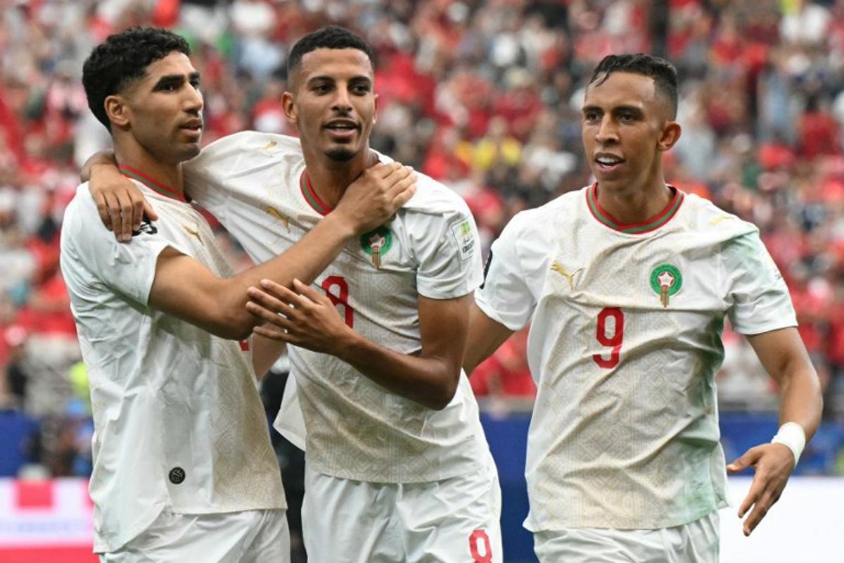 Morocco's midfielder #08 Azzedine Ounahi (C) celebrates scoring his team's first goal with teammates defender #02 Achraf Hakimi (L) and forward #09 Soufiane Rahimi (R) during the 2026 World Cup round of 16 football match between Canada and Morocco at the Houston Stadium in Houston on July 4, 2026. RONALDO SCHEMIDT / AFP