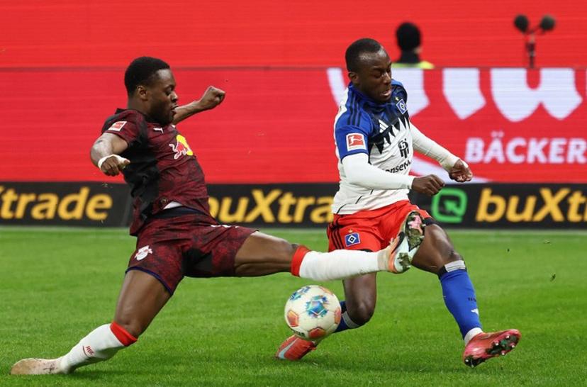 Leipzig's Austrian midfielder #14 Christoph Baumgartner (L) and Hamburg's French-Ivorian forward #07 Jean-Luc Dompe vie for the ball during the German first division Bundesliga football match between Hamburger SV and RB Leipzig in Hamburg, northern Germany on March 1, 2026. IBRAHIM OT / AFP