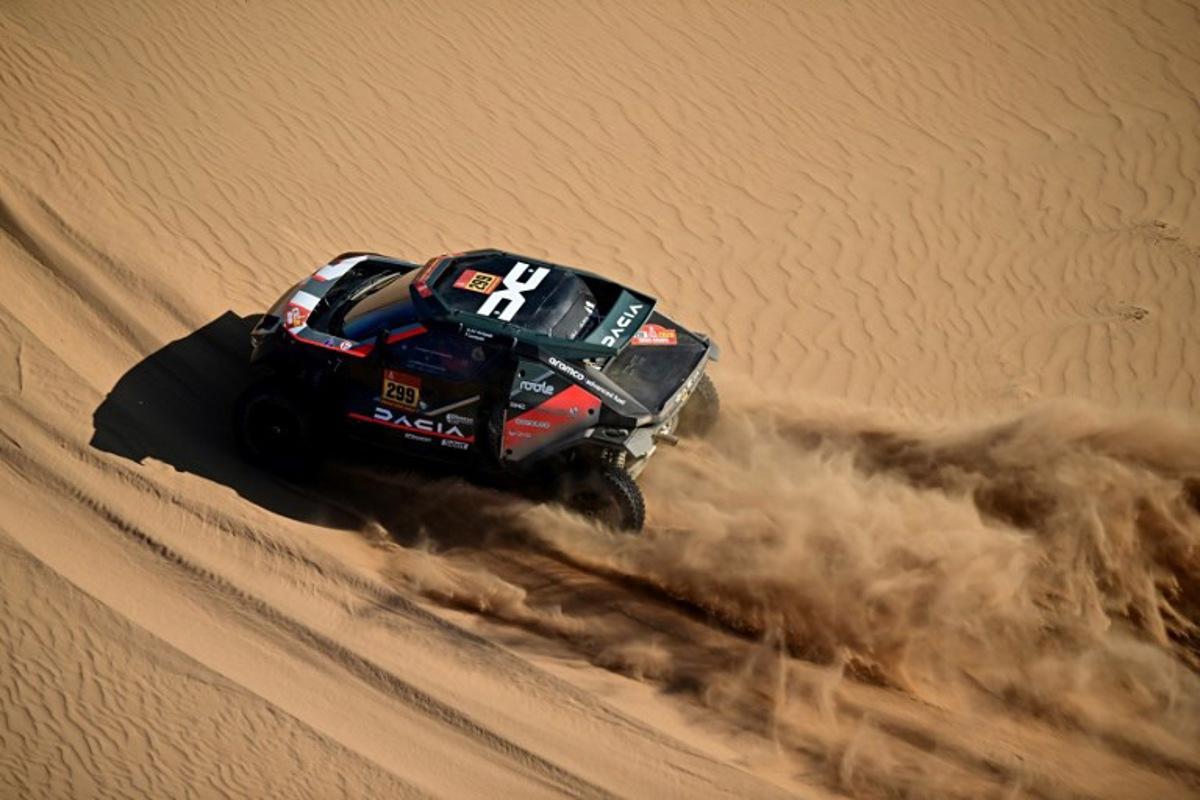 The Dacia Sandriders' Qatari driver Nasser Al-Attiyah and Belgian co-pilot Fabian Lurquin compete in Stage 9, a marathon stage, of the 48th edition of the Dakar Rally 2026, between Wadi ad-Dawasir and Bisha, Saudi Arabia, on January 13, 2026. Giuseppe CACACE / AFP