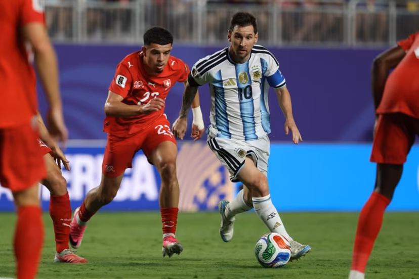 Argentina's forward #10 Lionel Messi runs with the ball followed by Switzerland's forward #23 Zeki Amdouni during the 2026 World Cup football tournament quarter-final match between Argentina and Switzerland at the Kansas City Stadium in Kansas City on July 11, 2026. Odd ANDERSEN / AFP