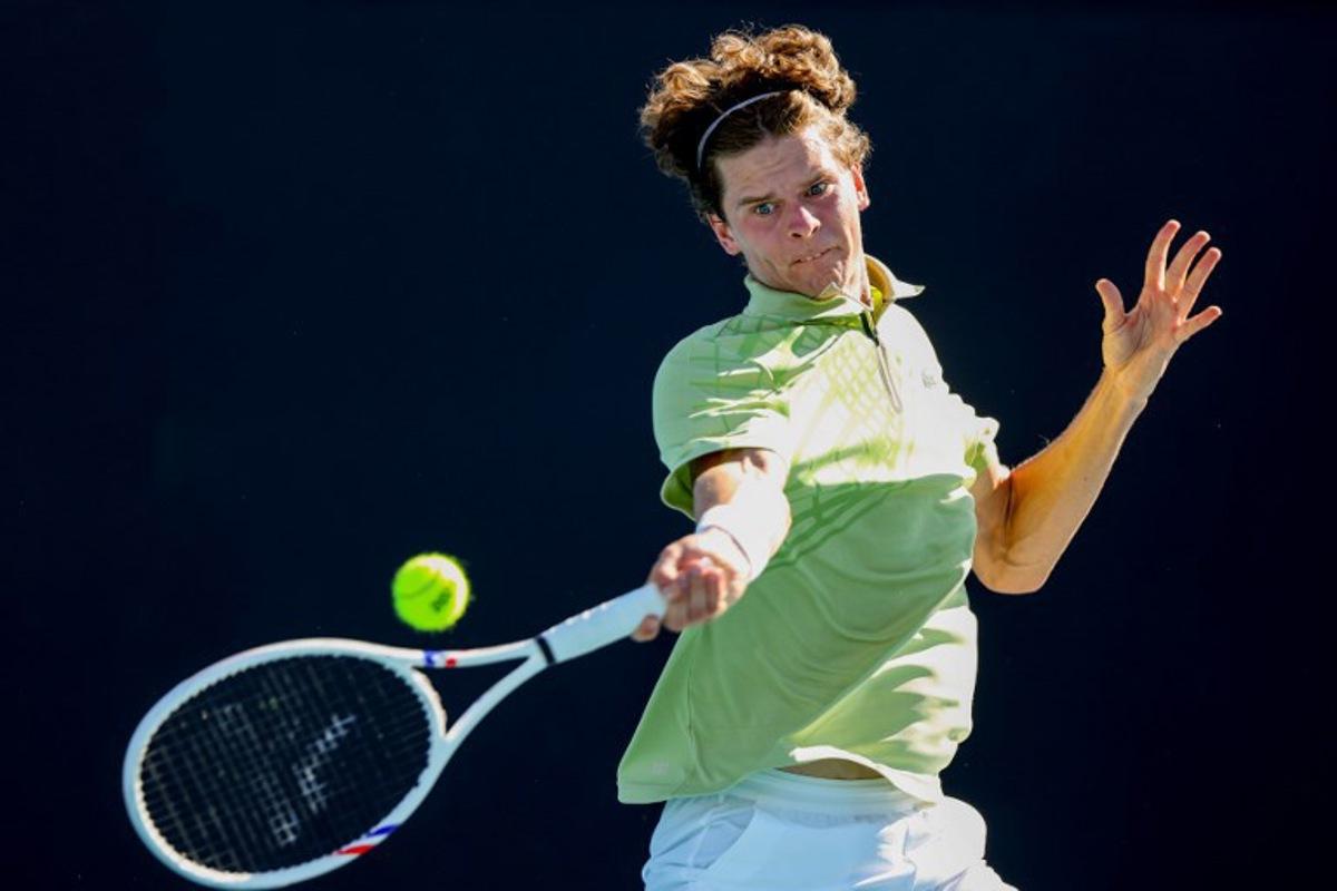 This handout picture released by Tennis Australia on January 18, 2026, shows Belgium's Alexander Blockx hits a return to Portugal's Jaime Faria during their men's singles match on day one of the Australian Open tennis tournament in Melbourne. /DYLAN PARKER Dylan PARKER / TENNIS AUSTRALIA / AFP