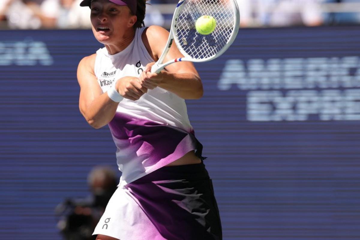 Poland's Iga Swiatek hits a return against China's Qinwen Zheng during their women's singles round of 16 tennis match on day nine of the US Open tennis tournament at the USTA Billie Jean King National Tennis Center in New York City on September 7, 2026. KENA BETANCUR / AFP