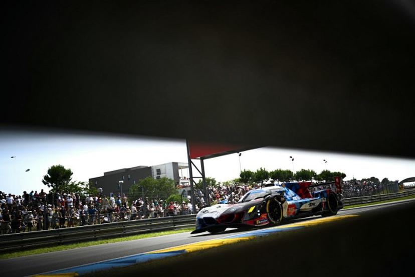 This photograph shows BMW M Team WRT's hypercar driven by Danish Kevin Magnussen, Italian Raffaele Marciello and Belgian Dries Vanthoor during the 94th edition of the 24 Hours of Le Mans at the Le Mans circuit, north-western France on June 13, 2026. Lou BENOIST / AFP