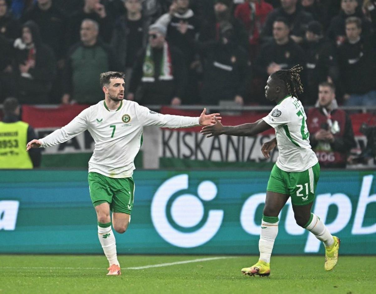 Ireland's forward #07 Troy Parrott (L) celebrates his 2-2 with Ireland's defender #21 Festy Ebosele during the FIFA World Cup 2026 Group F European qualification football match betweem Hungary and Republic of Ireland at the Puskas Arena in Budapest, Hungary on November 16, 2025. Attila KISBENEDEK / AFP