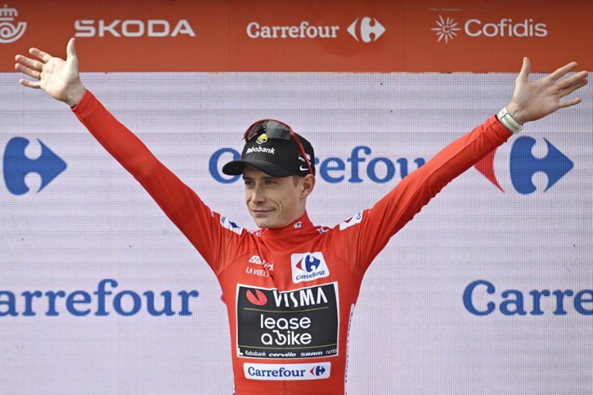 The overall leader Team Visma-Lease a bike's Danish rider Jonas Vingegaard celebrates on the podium wearing the red jersey after the tenth stage of the Vuelta a Espana cycling tour, a 168 km race between Sendaviva Natural Park in Arguedas and El Ferial Larra Belagua in Isaba, on September 2, 2025. Ander GILLENEA / AFP