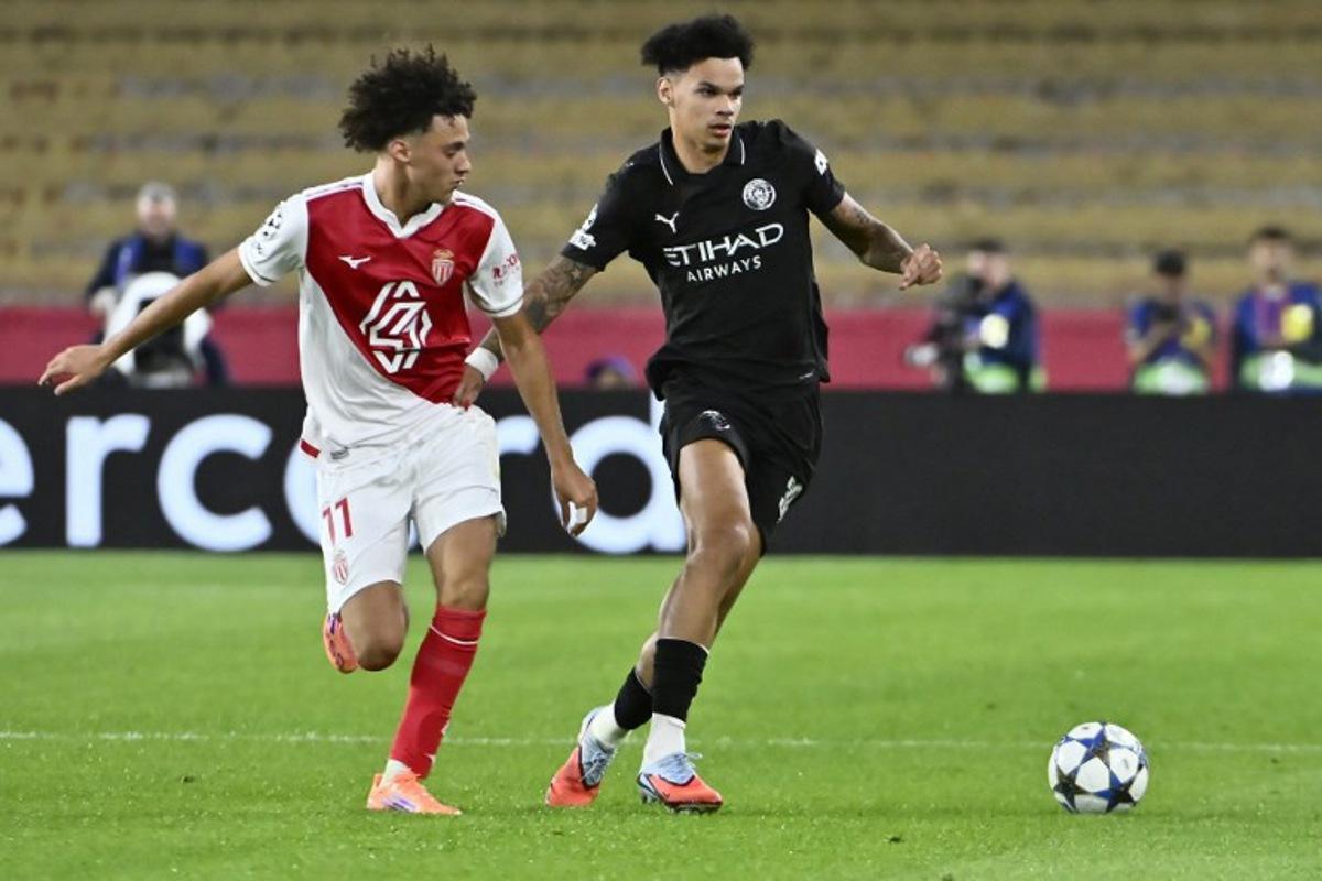 Monaco's French midfielder #11 Maghnes Akliouche (L) and Manchester City's English midfielder #33 Nico O'Reilly fight for the ball during the UEFA Champions League, league phase day 2, football match between Monaco and Manchester City at Stade Louis II, in Monaco on October 1, 2025. FREDERIC DIDES / AFP