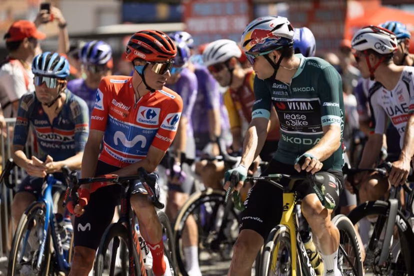 Overall leader Team Movistar's Spanish rider Enric Mas (L) speaks with points leader Team Visma-Lease a bike's Belgian rider Wout van Aert before the start of the 20th stage of the Vuelta a Espana 2026 cycling tour, a 186,8 km race between La Calahorra and Collado del Alguacil, on September 12, 2026. JORGE GUERRERO / AFP