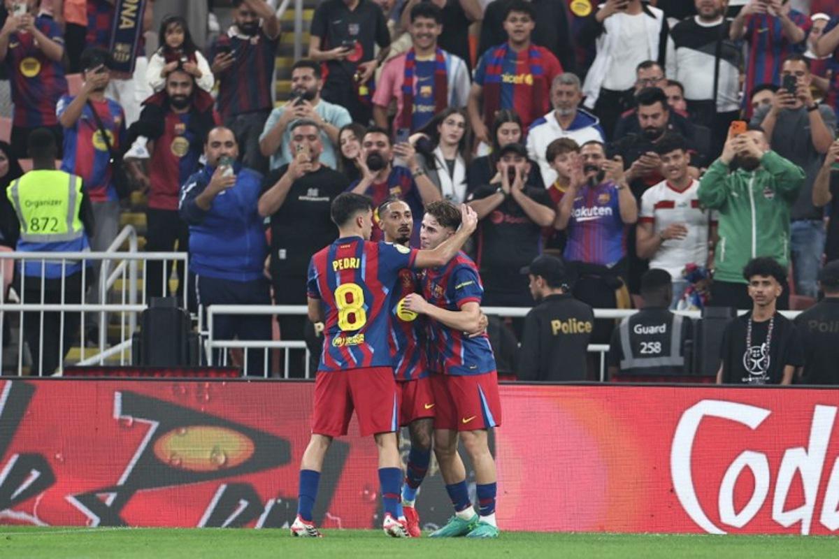 Barcelona's Spanish midfielder #16 Fermin Lopez (R) celebrates with teammates after scoring his team's second goal during the Spanish Supercup semi-final football match between FC Barcelona and Athletic Bilbao at King Abdullah Sports City in Jeddah on January 7, 2026. Fadel SENNA / AFP
